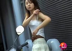 Asian cutie on a bike got really wet by a guy sharking video
